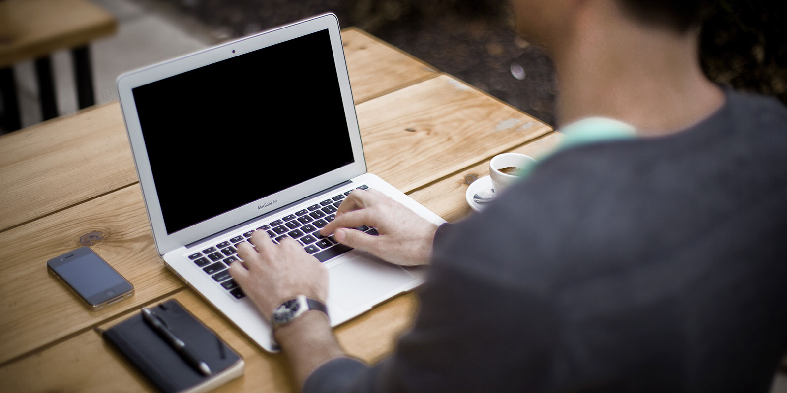 Person writing on a laptop